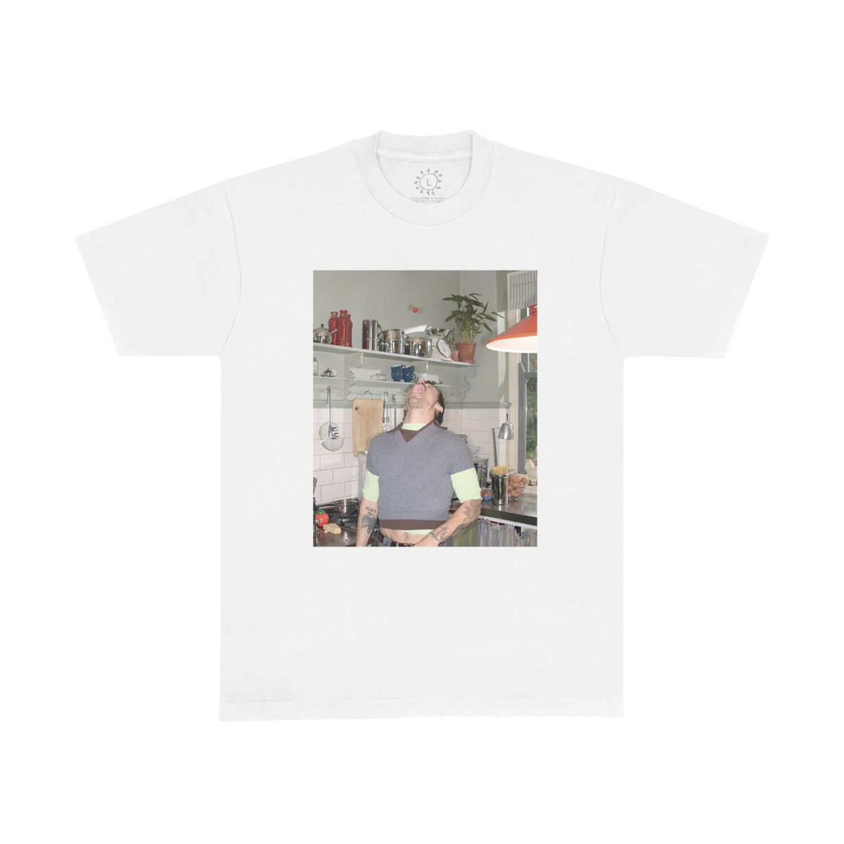White Harry Styles Good Catch T-shirt with a colour photo print of Harry in a plant-filled kitchen