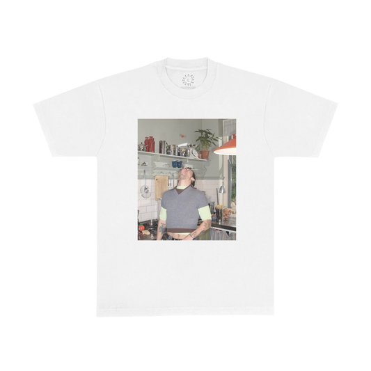 White Harry Styles Good Catch T-shirt with a colour photo print of Harry in a plant-filled kitchen