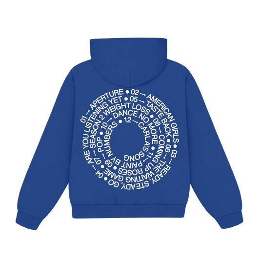 Back of blue Harry Styles tracklist hoodie with white spiral tracklist print across the back